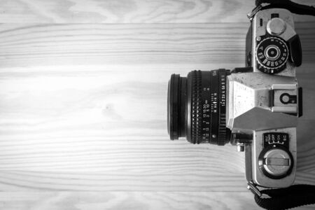 Old camera on wooden table (top view)の写真素材
