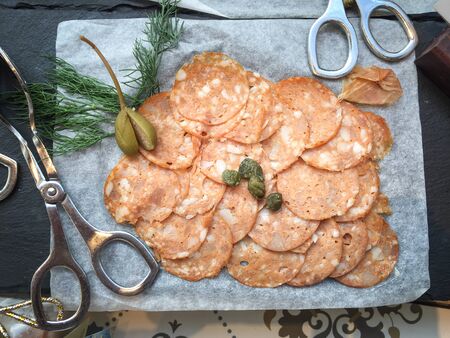 Mortadella (cold cut) with caper and dillの写真素材