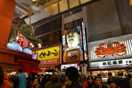 Many tourists visit Dotombori area, famous shopping and restaurant area, in Osaka, Japanのeditorial素材