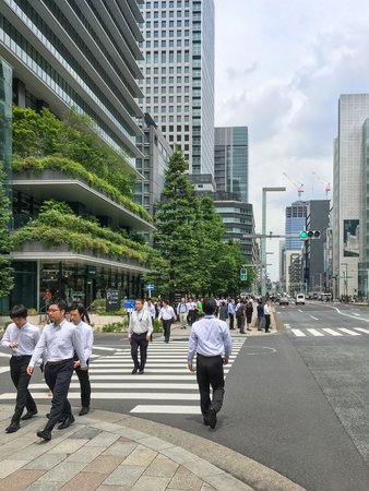 Many businessmen are walking along the Kyobashi commercial district near Ginza area during lunch time, Tokyo, Japanのeditorial素材