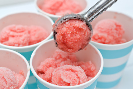 Homemade watermelon sorbet in blue paper cupの写真素材