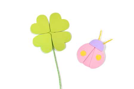 Four leaf clover and ladybug paper cut on white background - isolatedの写真素材