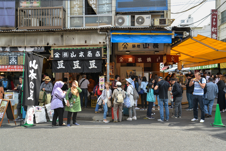 Tokyo, Japan - May 16, 2017: Many tourist are buying and eating variety of local food along the street at Tsukiji fish market, Tokyo, Japanのeditorial素材