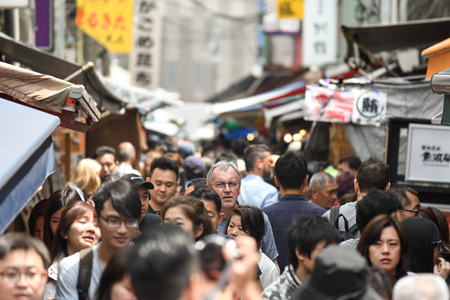 Tokyo, Japan - May 16, 2017: Many tourists are walking along local stores through the small alley at Tsukiji fish market, Tokyo, Japanのeditorial素材