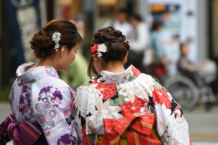 Tokyo, Japan - May 16, 2017: Women in Kimono are looking at their mobile phone along the street near Sensoji Temple, Tokyo, Japanのeditorial素材