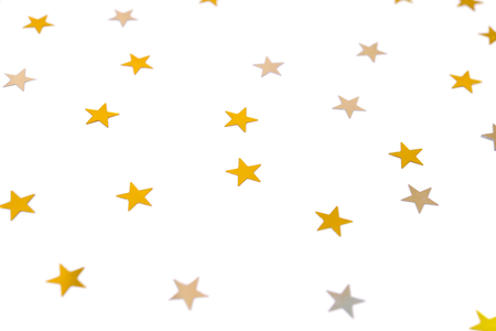 Gold star confetti on white backgroundの写真素材