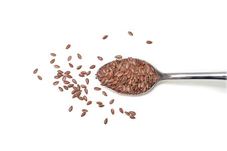 Brown flaxseeds  on white background - isolatedの写真素材