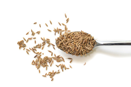 Cumin seed in a spoon on white background from top viewの写真素材