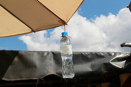 Plastic water bottle that is tied to hangの写真素材
