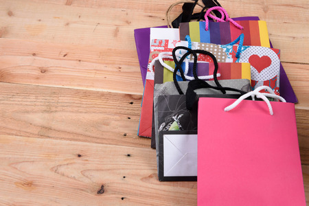 Paper shopping bags isolated on wood backgroundの写真素材