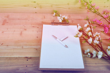Blank diary and pen on wood backgroundの写真素材