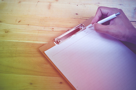 Blank diary and pen on wood backgroundの写真素材