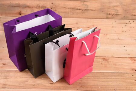 Paper shopping bags isolated on wood backgroundの写真素材
