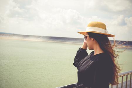 Women dressed in black with purple travel wallet,Traveling by road.の写真素材