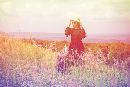 Women dressed in black with purple travel wallet,Traveling by road.の写真素材