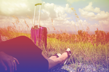 Women dressed in black with purple travel wallet,Traveling by road.の写真素材