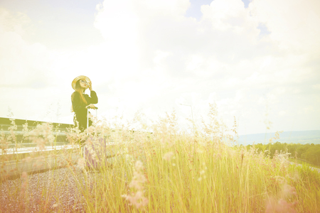 Women dressed in black with purple travel wallet,Traveling by road.の写真素材
