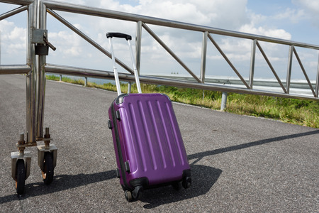 Women dressed in black with purple travel wallet,Traveling by road.の写真素材