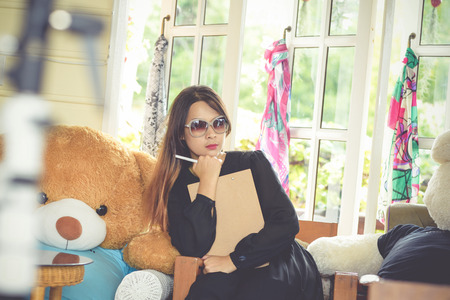 Women wearing black dress modeled in a cafe.の写真素材