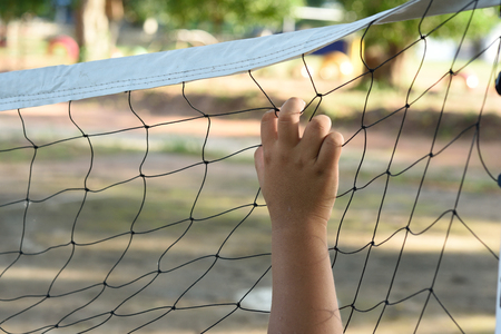 Hands with rope mesh fenceの写真素材
