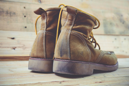 Old shoes and flower on a wooden background.Vintage Conceptの写真素材