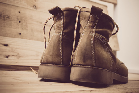Old shoes and flower on a wooden background.Vintage Conceptの写真素材