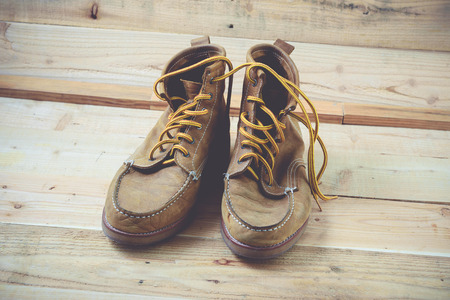 Old shoes and flower on a wooden background.Vintage Conceptの写真素材