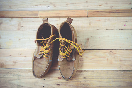 Old shoes and flower on a wooden background.Vintage Conceptの写真素材