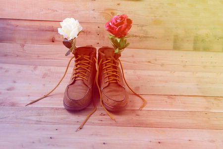 Old shoes and flower on a wooden background.Vintage Conceptの写真素材