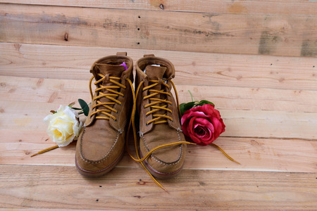 Old shoes and flower on a wooden background.Vintage Conceptの写真素材