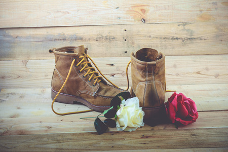 Old shoes and flower on a wooden background.Vintage Conceptの写真素材