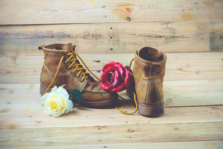 Old shoes and flower on a wooden background.Vintage Conceptの写真素材