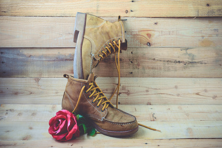 Old shoes and flower on a wooden background.Vintage Conceptの写真素材