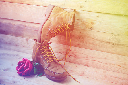 Old shoes and flower on a wooden background.Vintage Conceptの写真素材