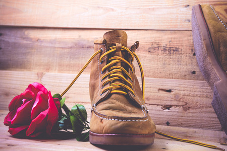 Old shoes and flower on a wooden background.Vintage Conceptの写真素材