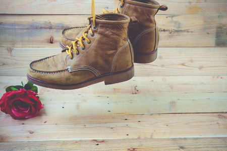 Old shoes and flower on a wooden background.Vintage Conceptの写真素材