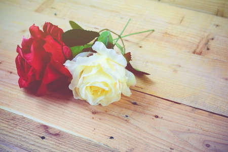 White and red roses on a wooden background.Vintage Conceptの写真素材