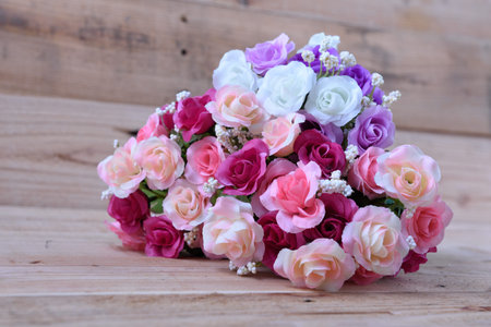 Flowers arranged on a wooden background.の写真素材
