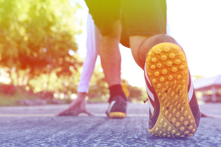 Athlete runner feet running on road closeup on shoe.の写真素材