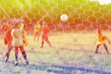 boys kicking football on the sports field,abtract blurの写真素材