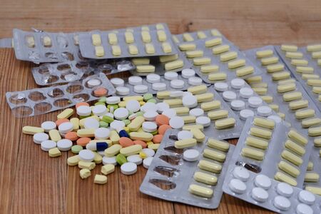 Many types of medicines Placed on a wooden background.の写真素材