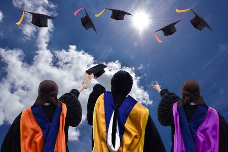 Graduates toss caps graduation congratulations.の写真素材