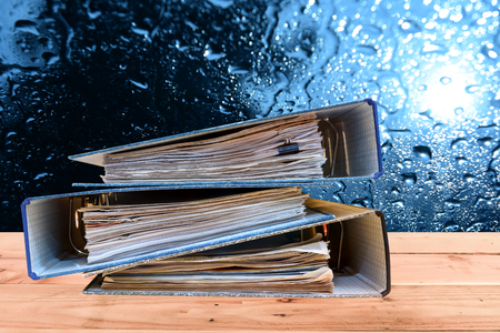a file folder with documents and important document,On a wooden backgroundの写真素材
