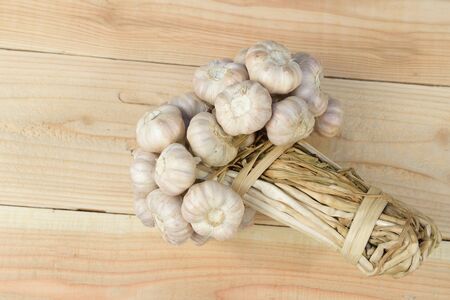 Place the garlic on a wooden floorの写真素材