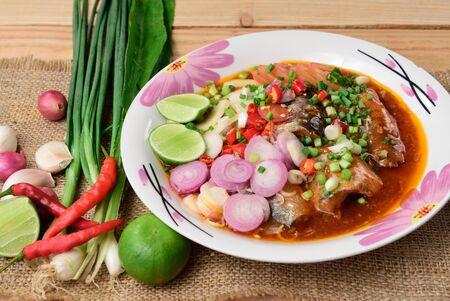 Canned fish salad,Spicy spices of Thailand on wood background.の写真素材
