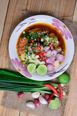 Canned fish salad,Spicy spices of Thailand on wood background.の写真素材