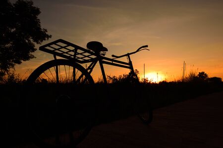 Vintage bike,Silhouette at sunset,dark tone Conceptの写真素材