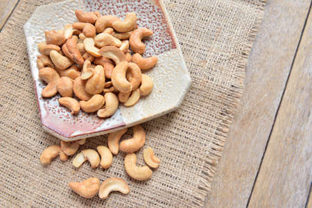 Cashews Put on a cup cashews,The background is made from sackの写真素材
