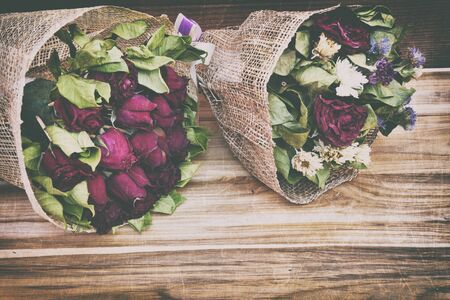 abstract rose,Dry red rose  dark tone on wood backgroundの写真素材