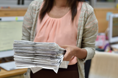 Female employees are handling the file.の写真素材